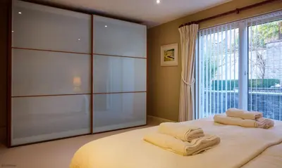 a bedroom with a bed with two towels on it at Underscar - Seatoller in Keswick