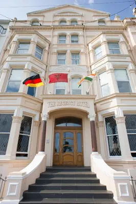 a building with two flags in front of it at Regency Hotel in Douglas