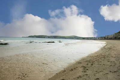 a sandy beach with the ocean in the background at Regency Hotel in Douglas
