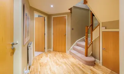 a hallway with a staircase in a house at Underscar - Whinlatter in Keswick