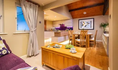 a living room with a couch and a dining room at Underscar - Whinlatter in Keswick