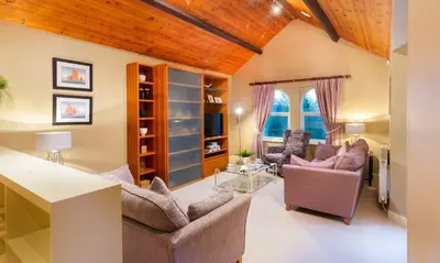 a living room with two chairs and a table at Underscar - Whinlatter in Keswick