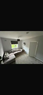 a living room with a couch and a window at Beautiful modern self-contained house in Moffat