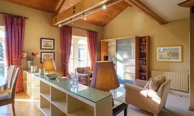 a living room with a glass table and chairs at Underscar - Great Gable in Keswick