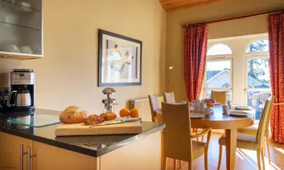 a kitchen with a table and a dining room at Underscar - Great Gable in Keswick