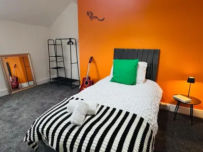 a bedroom with a bed with a green pillow at Vulcan Apartment - 3 Bedrooms - Sleeps 6 in Workington