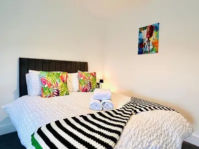 a bedroom with a bed with two towels on it at Vulcan Apartment - 3 Bedrooms - Sleeps 6 in Workington