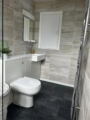 a bathroom with a toilet and a sink and a mirror at The Beach View - Greenan in Ayr