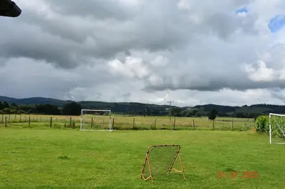 a soccer field with a goal in the grass at Rural luxury bungalow in Terreglestown