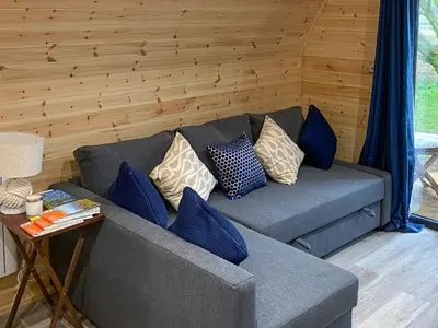 a gray couch with pillows on it in a room at The Eden Hideaway - Uk1554 in Rockcliffe