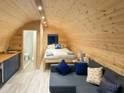 a bedroom with a bed and a couch in a room at The Eden Hideaway - Uk1554 in Rockcliffe