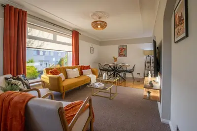 a living room with a couch and a table at The Bridge- 3 Bedrooms in Coatbridge with Driveway in Moffat