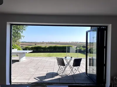 a view of a patio with a table and chairs at Tranquil Countryside Escape in Moffat