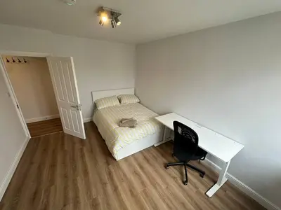 a bedroom with a desk and a bed and a desk and chair at 3x Large Double bedroom, Central London flat in Moffat