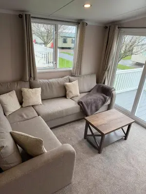 a living room with a couch and a coffee table at Paws A While in Mainsriddle