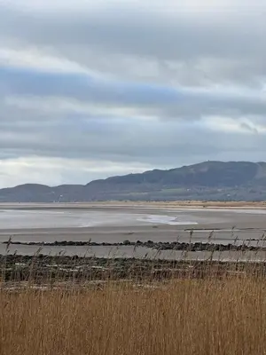 a large body of water with mountains in the background at Paws A While in Mainsriddle