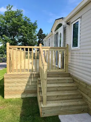 a wooden staircase leading up to a house at 29 The Beeches in Gilcrux