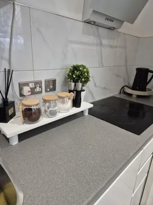 a kitchen with a counter with jars and plants at Modern & Cozy Apartment in the Heart of the City in Moffat
