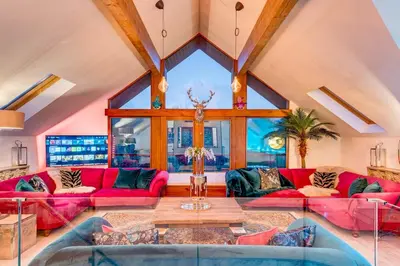 a living room with pink couches and a table at Luxury Lodge 18 by Ashgrove Leisure in Moffat