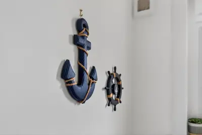 a large blue anchor hanging on a white wall at Troon Golf by the Sea in Troon