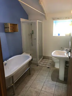 a bathroom with a tub and a toilet and a sink at A Hidden Gem in Cornwall in Moffat
