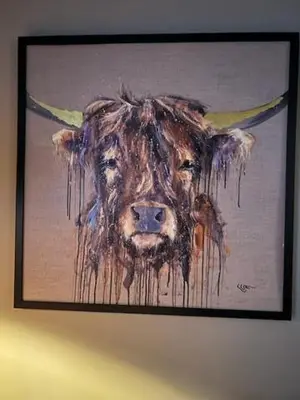 a painting of a cow is hanging on a wall at The Painted Cow in Beattock