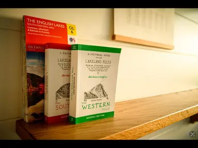 three books sitting on top of a wooden shelf at Laverock How Shepherds Hut with private hot tub in Seascale