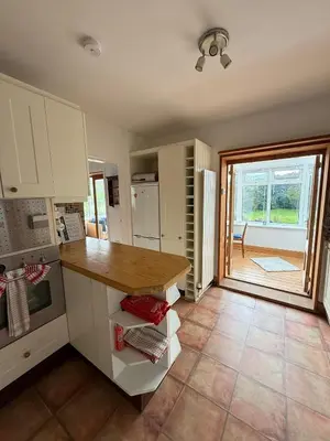 a kitchen with a counter and a large window at Wee Knockinaam, Portpatrick - clifftop seaview in Portpatrick