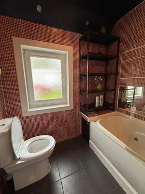 a bathroom with a toilet and a tub and a window at Wee Knockinaam, Portpatrick - clifftop seaview in Portpatrick