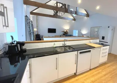 a kitchen with a sink and a refrigerator at Outstanding Converted Mill in Beautiful Location - Pass the Keys in Gatehouse of Fleet