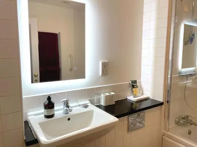 a bathroom with a sink and a mirror and a shower at Outstanding Converted Mill in Beautiful Location - Pass the Keys in Gatehouse of Fleet