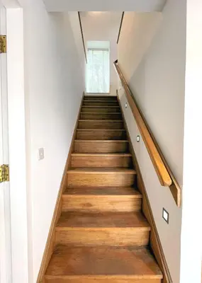 a staircase in a house with wooden floors at Outstanding Converted Mill in Beautiful Location - Pass the Keys in Gatehouse of Fleet
