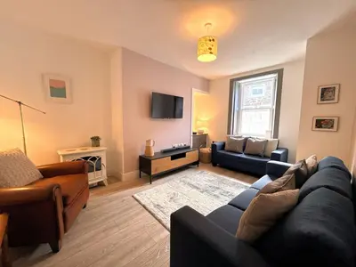 a living room with a couch and a tv at Beautifully Presented Cosy Home in Kirkcudbright - Pass the Keys in Kirkcudbright