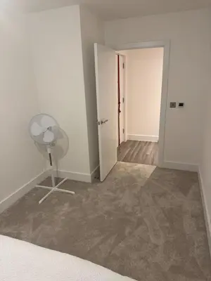 an empty room with a fan and a door at Colindale Condominium in Moffat
