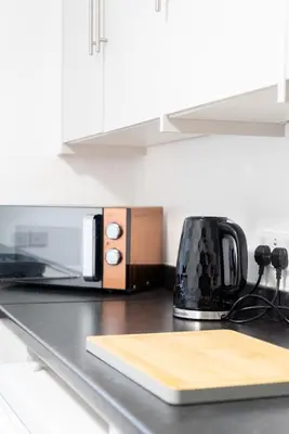a kitchen counter with a toaster oven and a toffeettel at Newton Flat in Carlisle