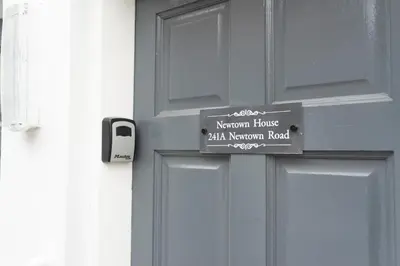 a wooden door with a sign on it at Newton Flat in Carlisle