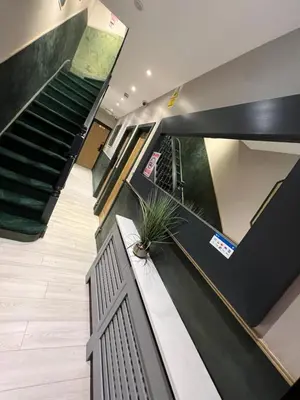 a staircase in a building with a potted plant at Rest Inn Edmonton in Moffat