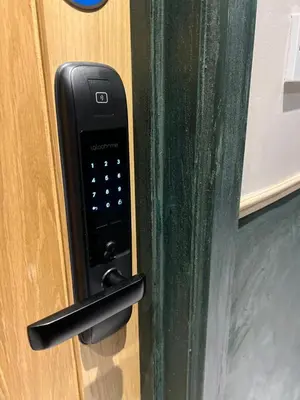 a black cell phone on a door handle at Rest Inn Edmonton in Moffat
