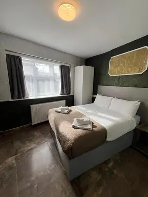 a bedroom with a bed with two plates on it at Rest Inn Edmonton in Moffat