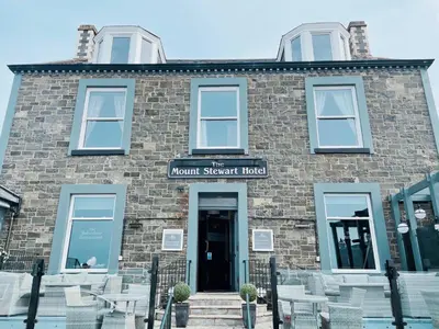 a brick building with a sign that reads mount stewart lived at Mount Stewart Hotel in Portpatrick