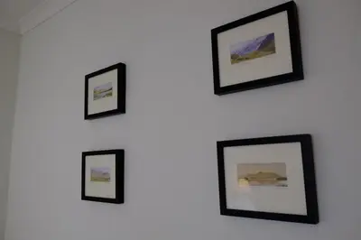 a group of framed pictures on a wall at Skiddaw Croft Bed & Breakfast in Keswick