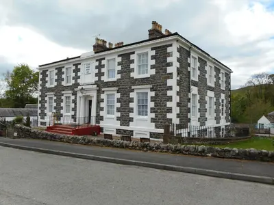 a large brick building on the side of a street at Telford Manor House in Beattock