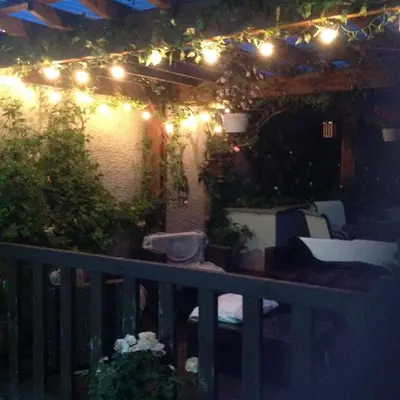 a patio with lights and plants on a balcony at Midtown Farm Bed & Breakfast in Easton