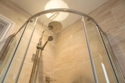 a shower with a shower head in a bathroom at Hermiston Guest House in Keswick