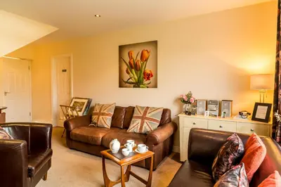 a living room with a couch and a table at Hermiston Guest House in Keswick