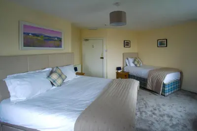 a hotel room with two beds in a room at The Harbour Inn in Garlieston