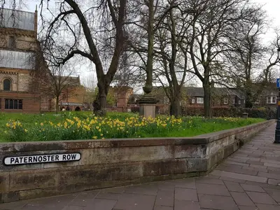 a stone retaining wall with flowers in a park at The Sawmills, Carlisle - Spacious 4 Bedroom Family House - Free WiFi - & Parking - Walk to Carlisle Castle in Carlisle