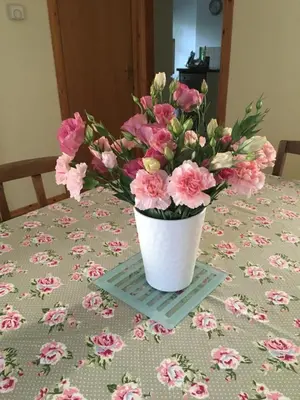 a vase of pink flowers sitting on a table at Ballacowell in Sulby