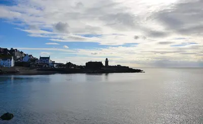 a view of a body of water with a lighthouse at Crown hotel in Portpatrick