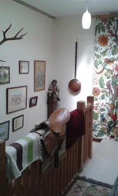 a bedroom with a bed with a saddle on it at Beech House in Greystoke